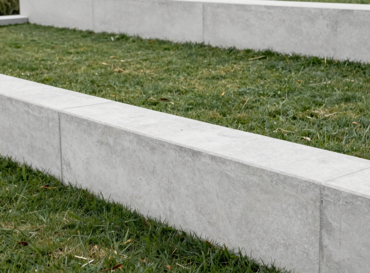 Clean geometric concrete retaining wall bordering a minimalist modern lawn, sharp architectural lines, soft daylight